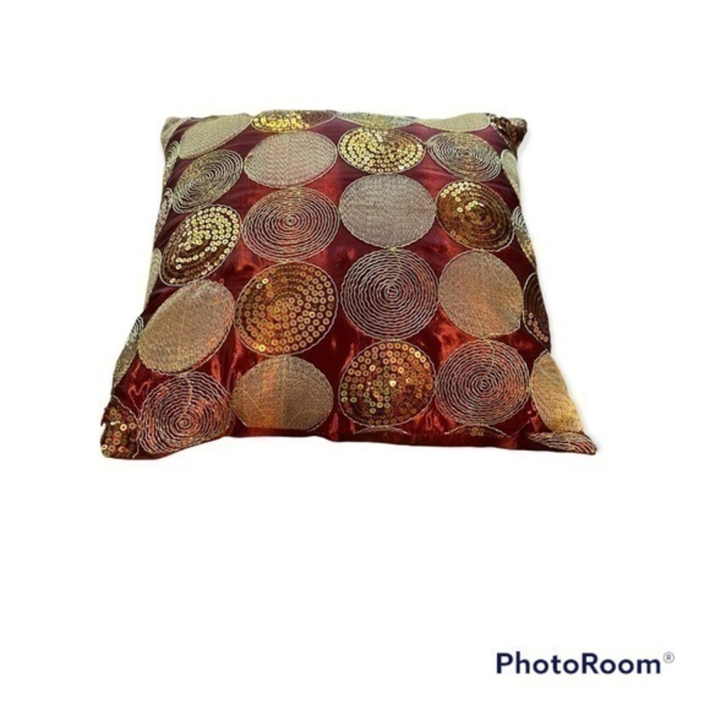 Dark red pillow with gold accents